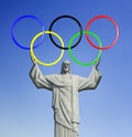 Rio 2016. Christ the Redeemer, on top of Corcovado mountain in Rio de Janeiro. Holding Olympic rings. Royalty Free Stock Photo